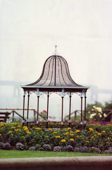 The mini bandstand and surrounding flower beds, with the River Tay visible in the distance.