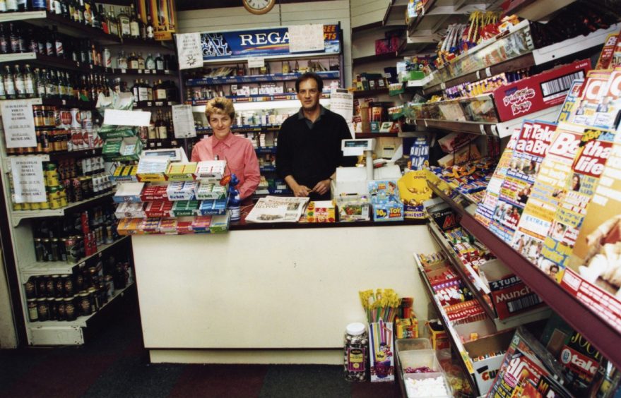 Two workers behind the counter at W&J Fitzgerald’s newsagent at 298 Perth Road,