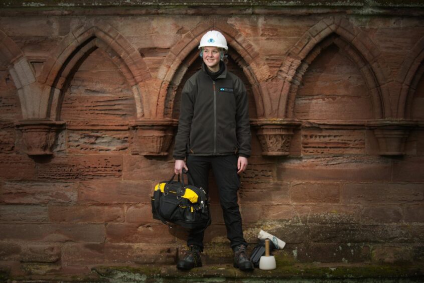 Apprentice HES stonemason Sarah Tebbs at Arbroath Abbey.