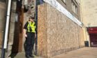 Police remain outside the derelict shop on High Street in Kirkcaldy where the suspected drugs factory was discovered.