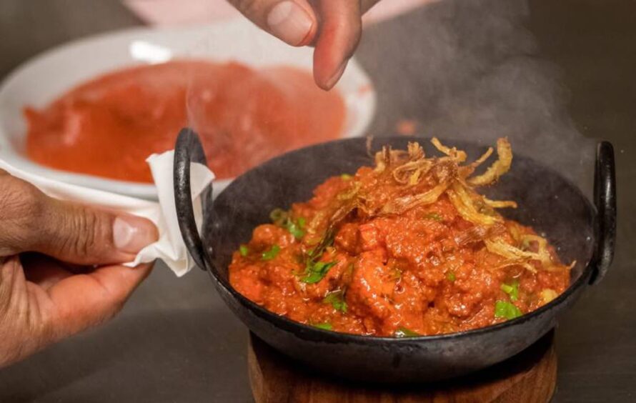 a curry being served in a small bowl