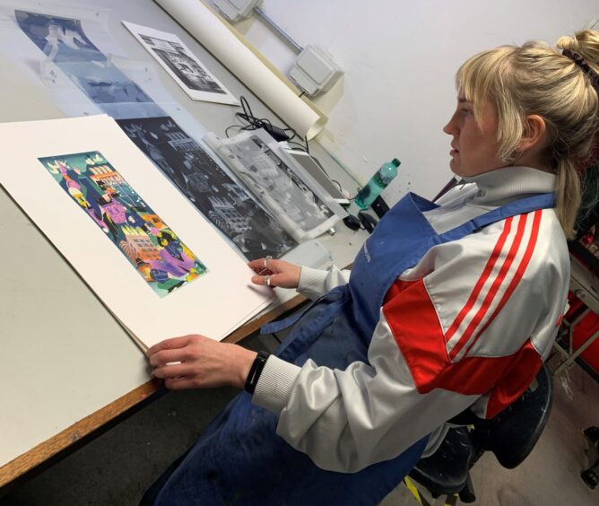 Image shows: illustrator Kate Benzie with her Dundee Matters prints at the DCA Print Studio.