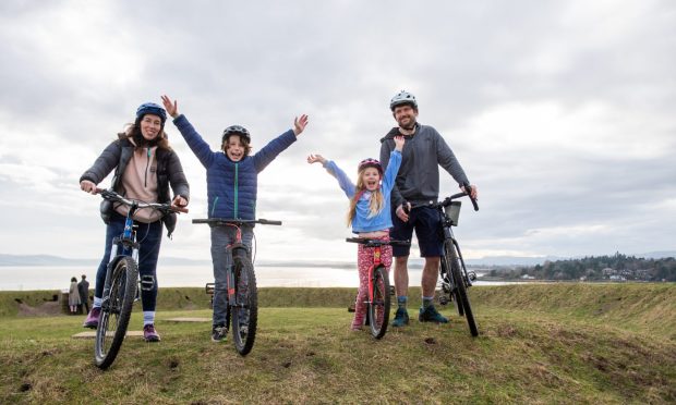 Ramsay, Iris, Gail and PJ Meiklem standing with bikes at Riverside Nature Park.