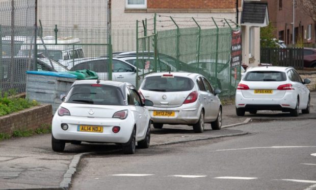 Cars parked on the pavement on Buttars Loan, Dundee