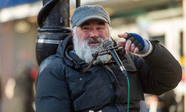 CR0050927, Poppy Watson, Dundee. Pictures and video footage of Eric Gudmunsen busking outside the Overgate? Mix of posed and candids would be nice. Picture Shows; Eric Gudmunsen busking outside the entrance to the Overgate Shopping Centre, High Street, Dundee, 19th Nov 2024. Image: Kim Cessford / DC Thomson