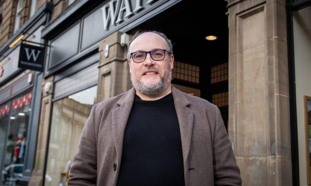 Novelist Russel D. McLean standing outside the Waterstones on Dundee's Commercial Street where he used to work.