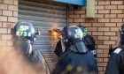 Police using cutting equipment to enter the Glenrothes industrial unit. Image: Kenny Smith/DC Thomson