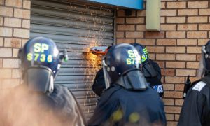 Police using cutting equipment to enter the Glenrothes industrial unit. Image: Kenny Smith/DC Thomson