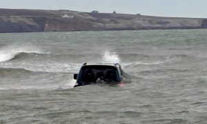 The car became engulfed by waves during the high tide. Image: Lunan Bay Communities Partnership