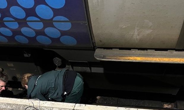 Janet Bellis being attended to by the paramedics after falling at Dundee railway station. Image: Ian Bellis.