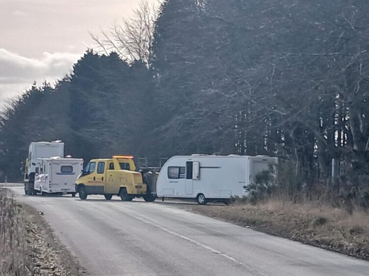 Caravans being towed from Balmuir Wood on Monday.