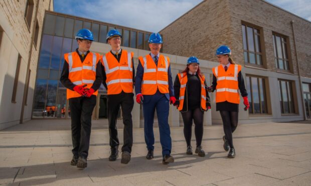 CR0052506 - Cheryl Peebles Story  - Dundee area - Tour of new Greenfield Academy and and Drumgeith Community Campus site -   - Picture shows scenes from the tour  --- left to right is Campbell Kirk and Ollie Maxwell (4th years from Craigie) Head Teacher Johnny Lothian, alongside Ava-Grace McGuire and Daiyna Murray (4th years at Braeview)
 -- Greenfield Academy and Drumgeith Community Campus, Drumgeith Road, Dundee -  Wednesday 19th March 2025  - Image: Steve MacDougall/DC Thomson