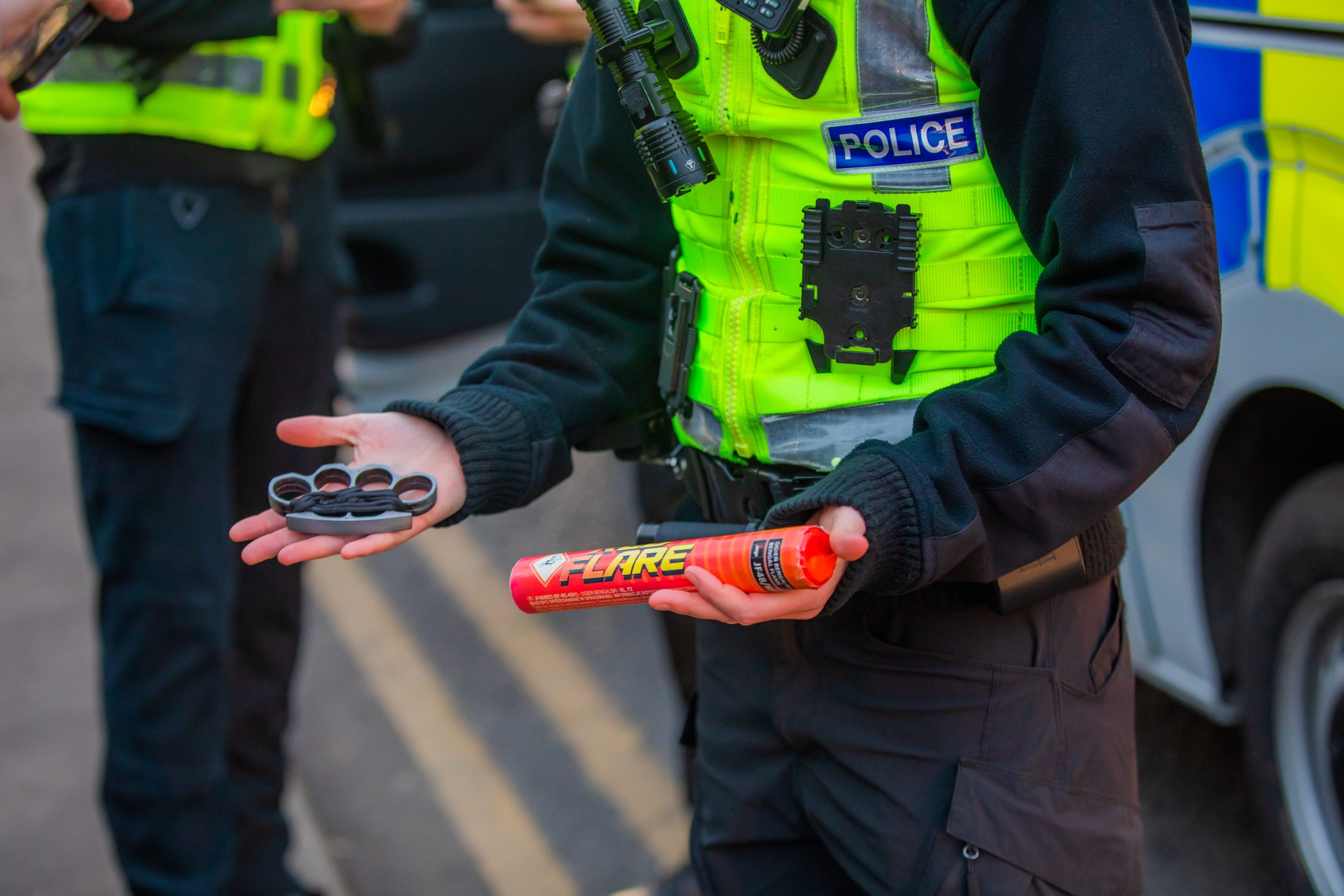 An officer shows the knuckleduster and flare found in the search of the 15-year-old.