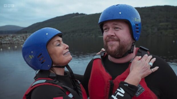 Judith Ralston and Grado got a bit wet while paddleboarding in Loch Tay. Image: BBC Scotland