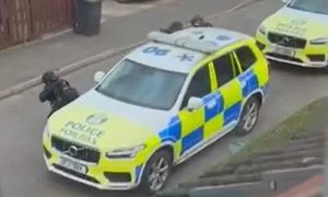 Police could be seen pointing their guns at a house during the stand-off on Earlston Avenue, Dundee. Image: Facebook