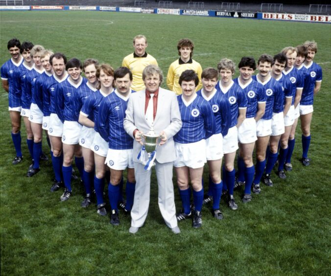 St Johnstone lined up on the pitch with the First Division trophy. 