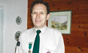 Stewart Duff in Scout leader uniform receiving Medal of Merit award. Image: Jenny Duff