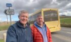 Cults Hill man Robert Gillan, right, with Willie Rennie MSP, at the bus stop sign he erected