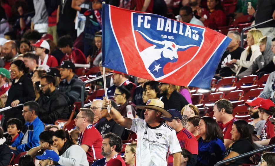 An FC Dallas fan waves a flag in their ground.