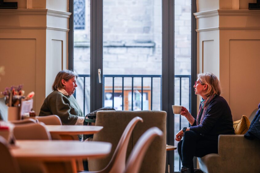 Two women at window seat inside Perth Museum cafe