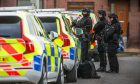 Armed police outside the house on Earlston Avenue in Dundee.