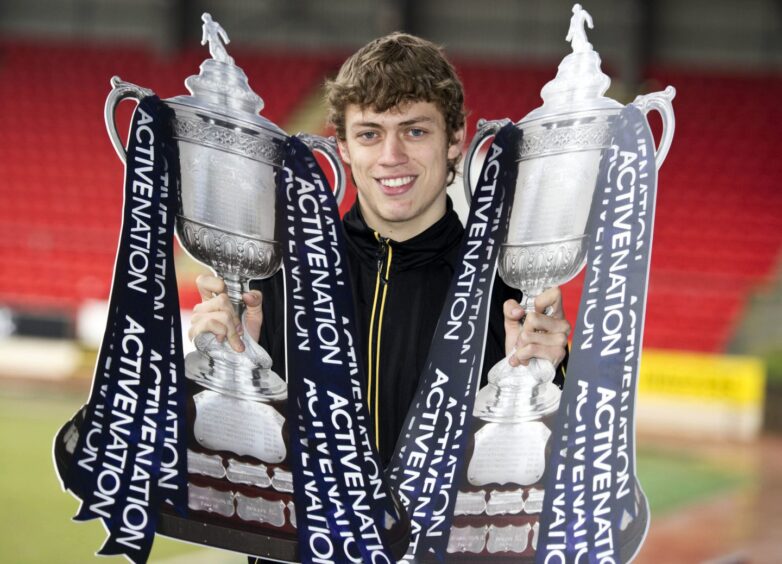 Murray Davidson in 2010 with two cardboard Scottish Cup trophies.