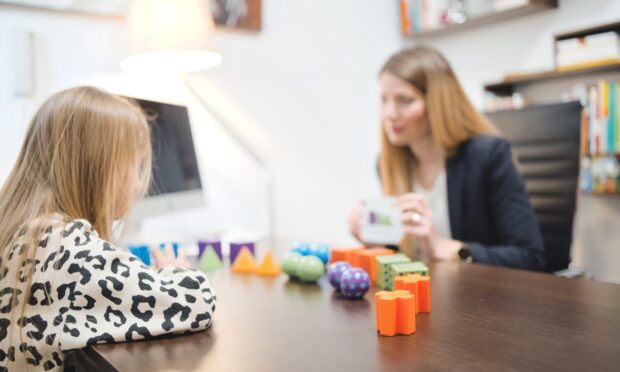 Valencia,España - APRIL 24 2023 Assessment of children's mental development. Unidentified professional psychologist observing young child playing with logic game, assessing her readiness for school.; Shutterstock ID 2293862119; purchase_order: ; job: