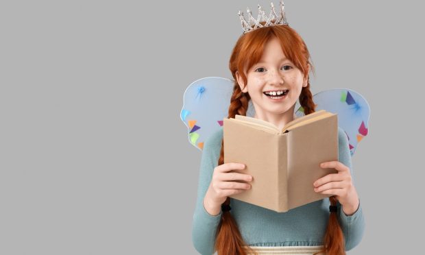 Cute redhead fairy reading book on grey background; Shutterstock ID 2589986917; purchase_order: ; job: