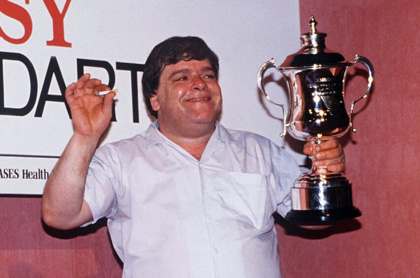 Jocky lifts the trophy after he wins the 1989 world darts championship