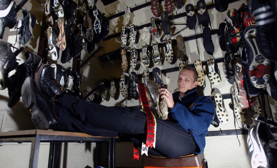 Tommy Lovenkrands polishing the Scottish Cup in 2003.