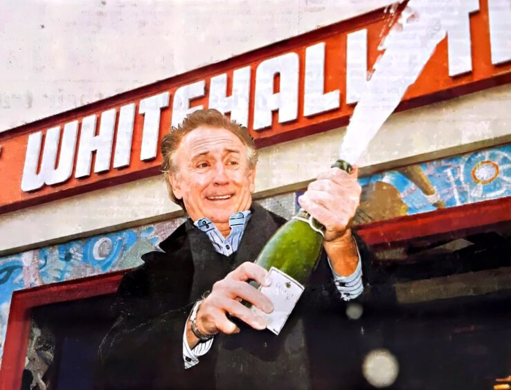 Tony Christie cracks open the bubbly outside the Whitehall Theatre in Dundee.