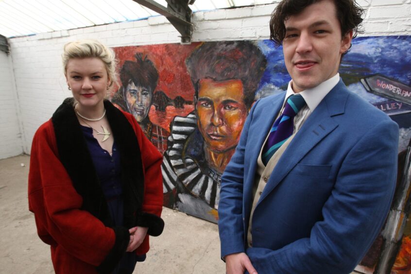 Stuart Adamson's children, now grown up, beside their dad's mural at East End Park in 2009.