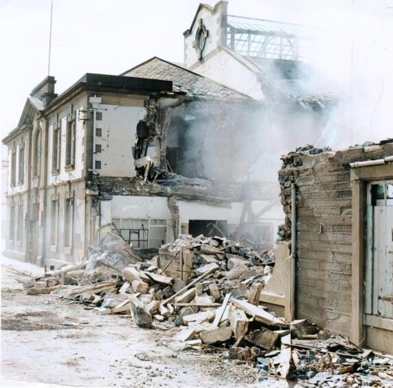 rubble on the pavement as the old baths are demolished. 