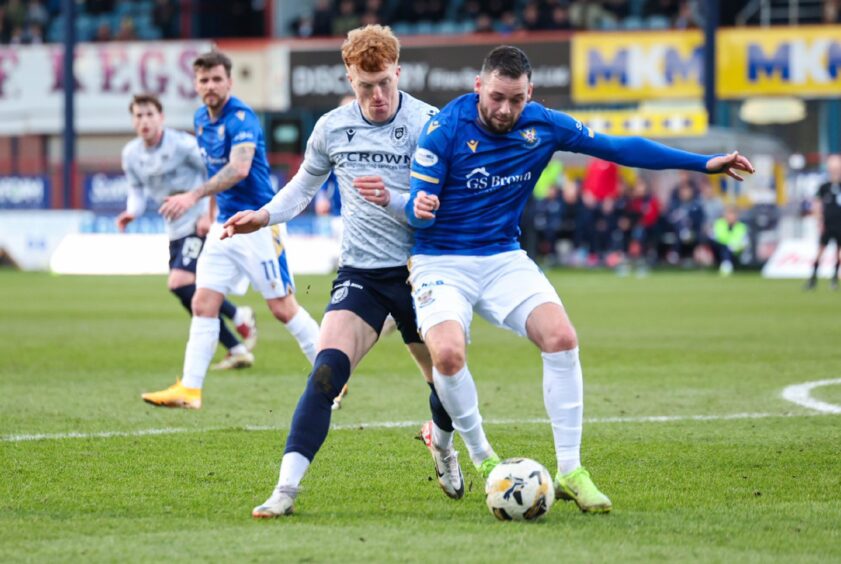 Drey Wright and Simon Murray battle for the ball.