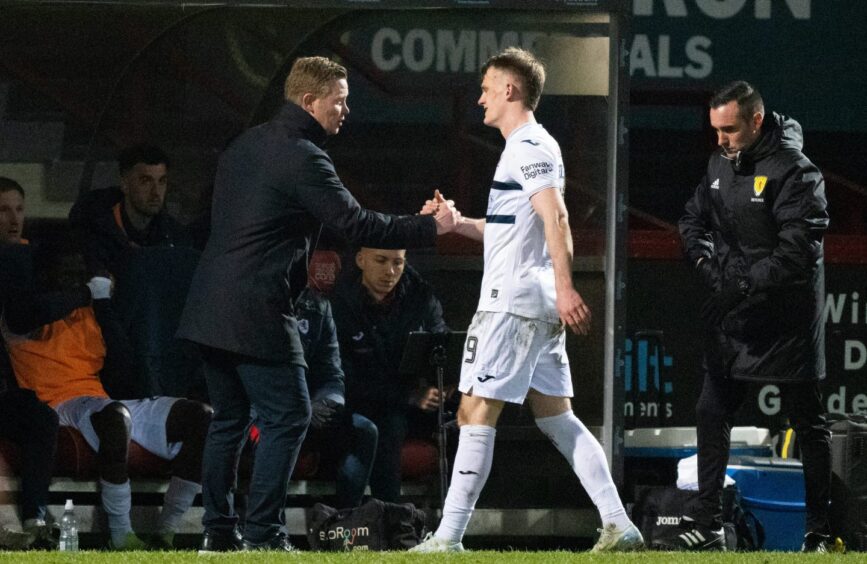 Finlay Pollock and Raith Rovers boss Barry Robson shake hands.