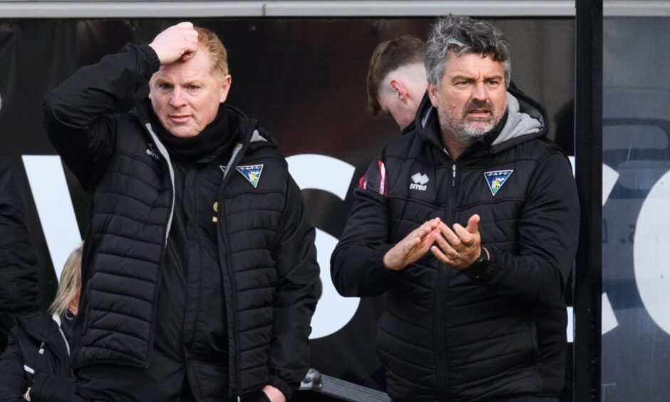 Dunfermline Athletic assistant Iain Brunskill claps his hands as manager Neil Lennon scratches his head.