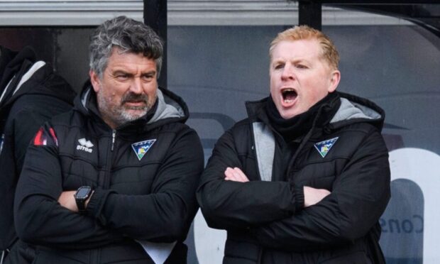 Dunfermline Athletic boss Neil Lennon and assistant Iain Brunskill stand on the touchline with their arms folded.