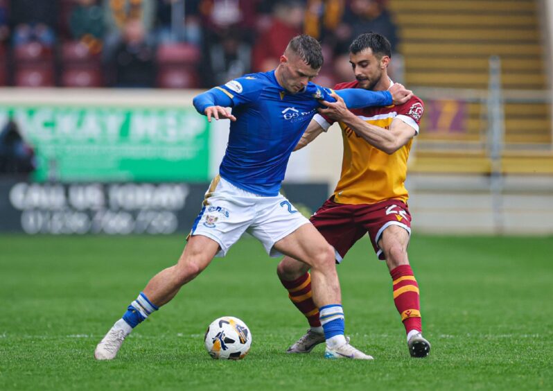 Josh McPake trying to hold off a Motherwell defender. Image: SNS.
