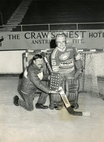 Darts player Jocky Wilson on the ice. 
