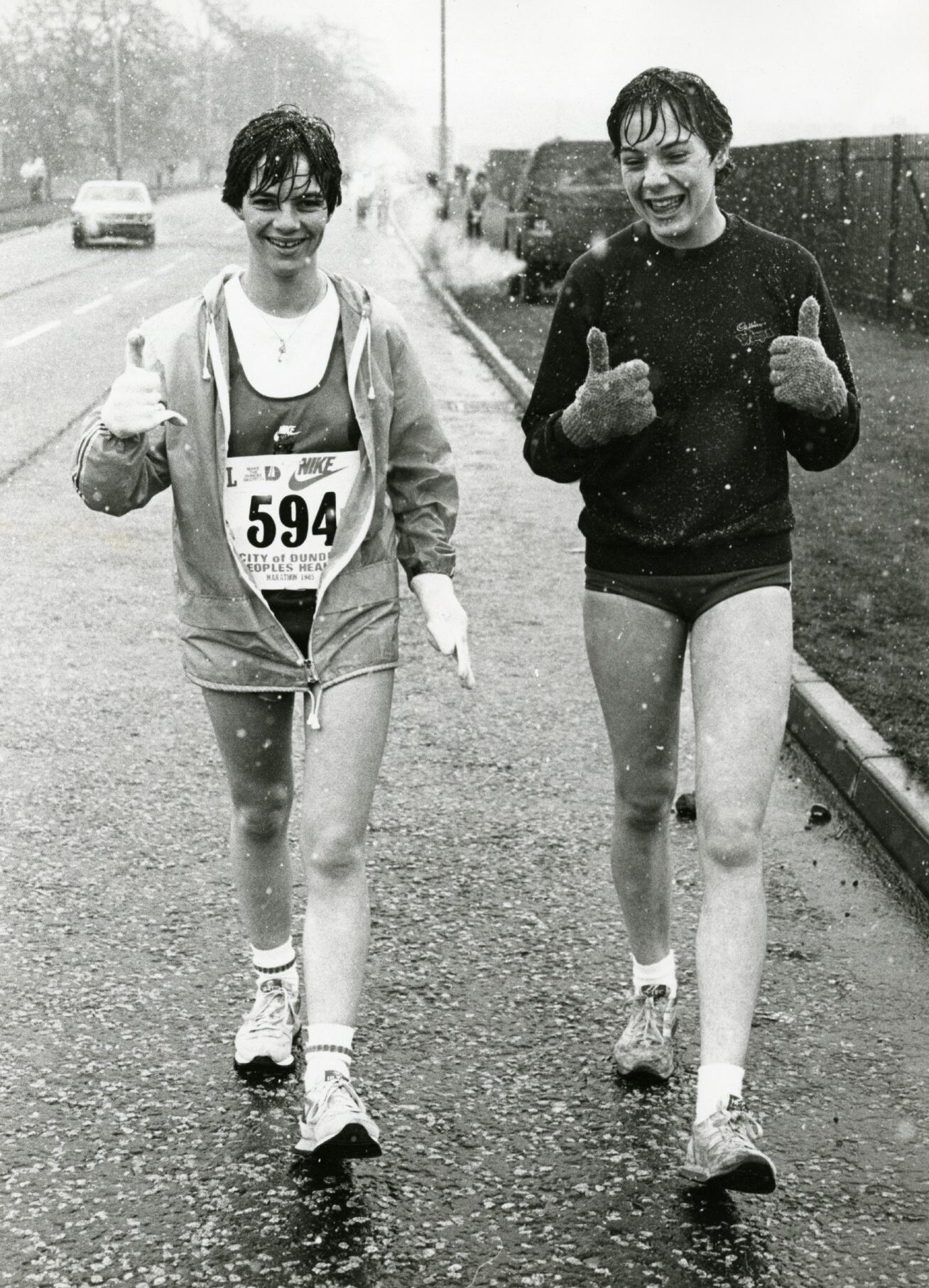 A pair of wet runners give a thumbs up