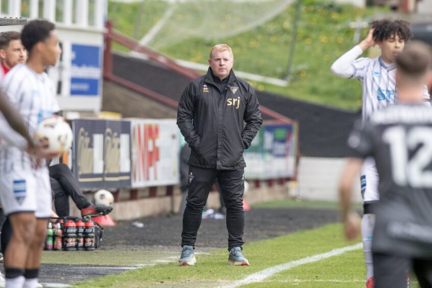 Dunfermline Athletic manager Neil Lennon stands with his hands in his jacket pockets.