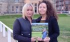 Louise Coyne (left) and Ellie Laird with a copy of David's posthumous book at the Old Course, St Andrews. Image: Michael Alexander