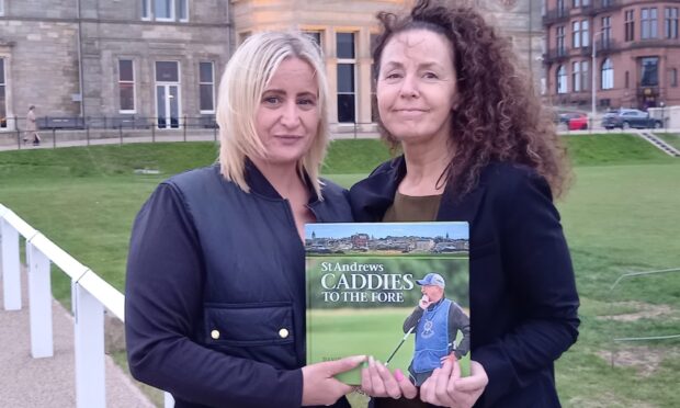 Louise Coyne (left) and Ellie Laird with a copy of David's posthumous book at the Old Course, St Andrews. Image: Michael Alexander
