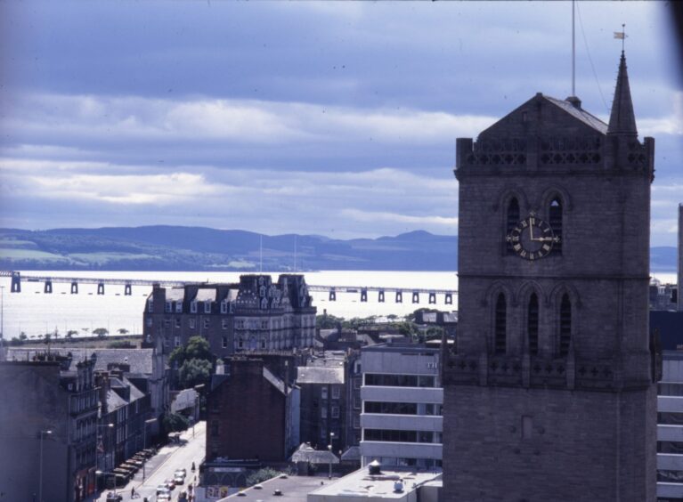 an aerial shot where the six-storey Angus Hotel is partly hidden by the Old Steeple in the foreground while the Queen's Hotel stands in the background on the Nethergate.