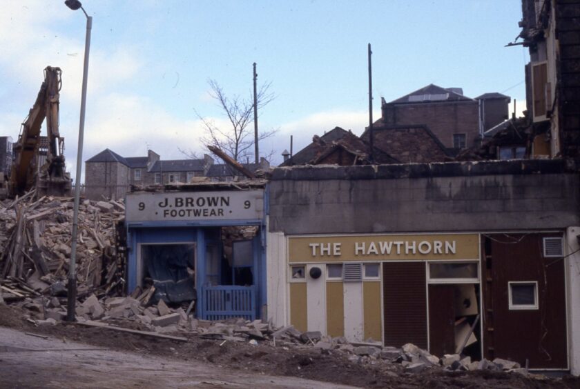 a digger on the scene as The Hawthorn Bar at 1-11 Hilltown is demolished