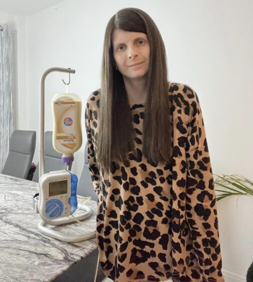 Danielle with the PEG machine which tube feeds her.