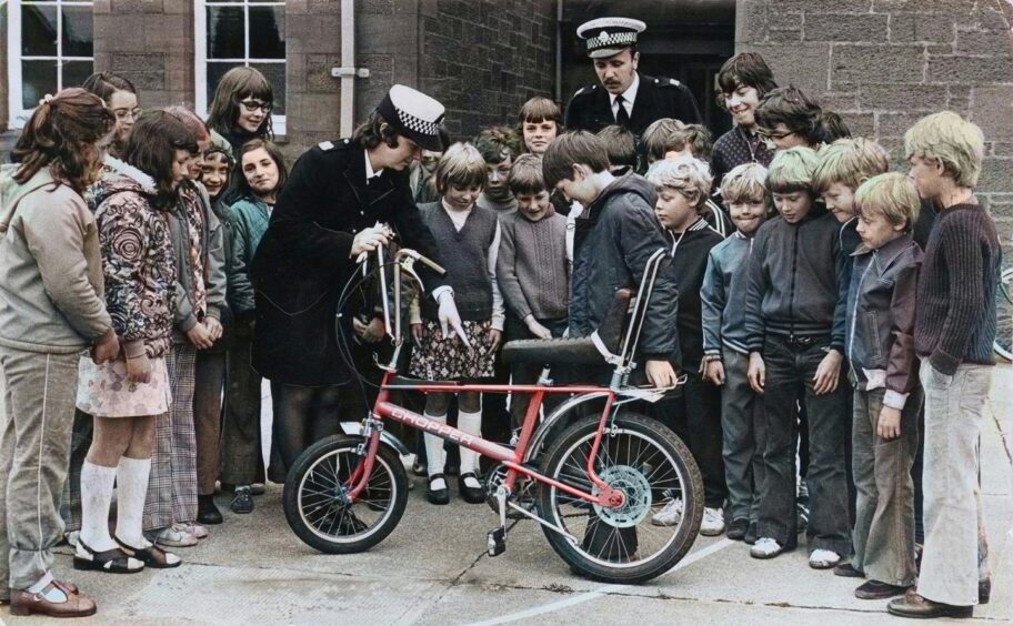 Children from Downfield getting cycle proficiency training from Tayside Police with a Raleigh Chopper in July 1975.