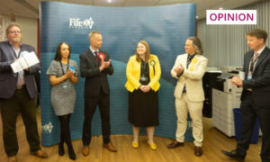 Candidates including Reform's Ian Smith (far left) congratulate SNP's Lynda Holton as returning officer Ken Gourlay announces the result. Image: Fife Council