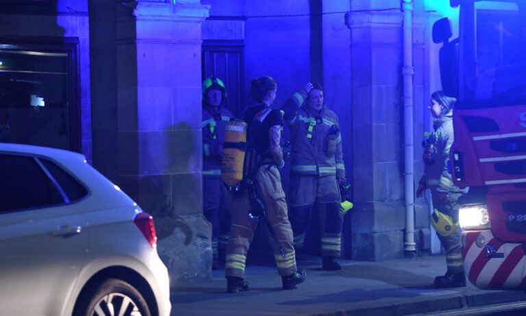 Firefighters wearing breathing apparatus tackle blaze at Perth flat