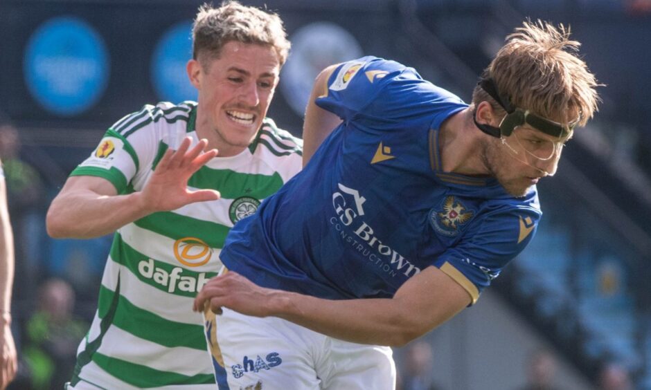 Daniels Balodis, wearing a mask, holds off Luke McCowan.